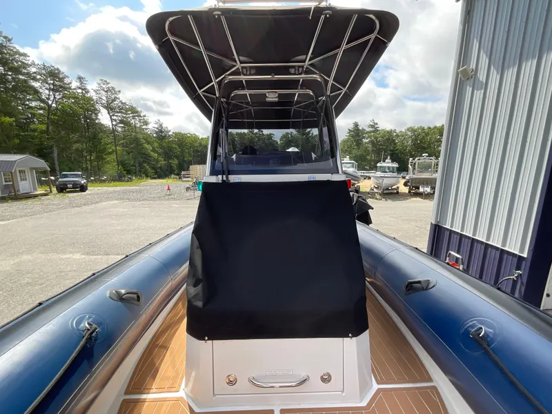 Slide: The Image of 2019 Protector 310 Chase boat with canopy, docked outdoors on a sunny day. - 4