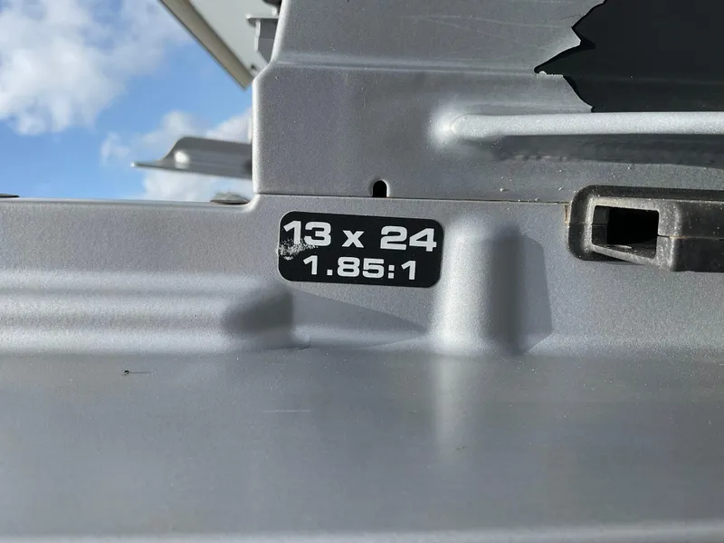 Slide: The Image of Close-up of a Protector 310 Chase 2019 boat part with "13 x 24 1.85:1" label. - 40