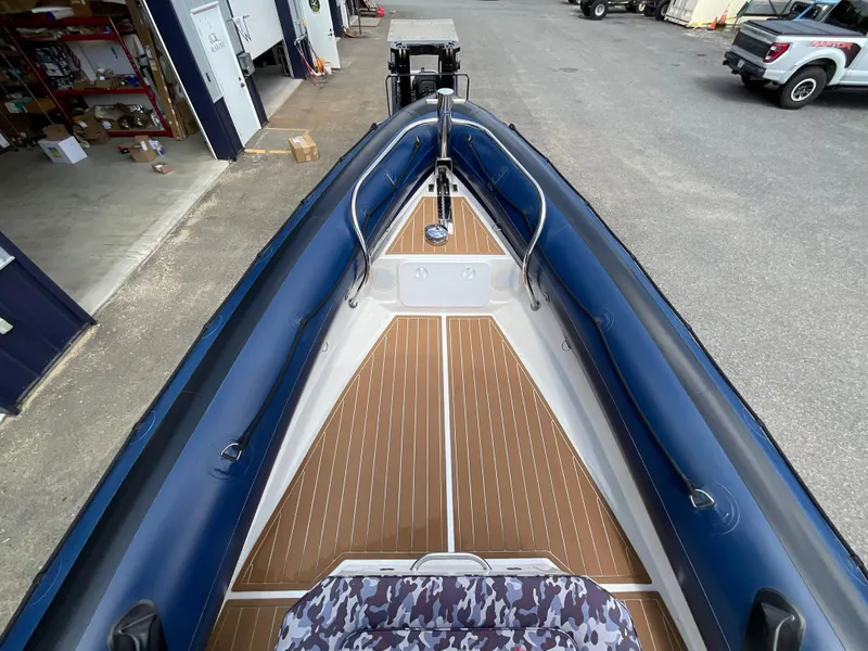 Slide: The Image of 2019 Protector 310 Chase boat interior with blue and brown accents, docked in a marina. - 6
