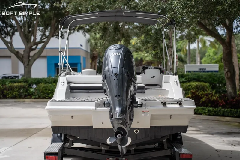 Slide: The Image of 2025 Starcraft SVX 231 OB DH boat with powerful outboard motor, parked outdoors. - 6