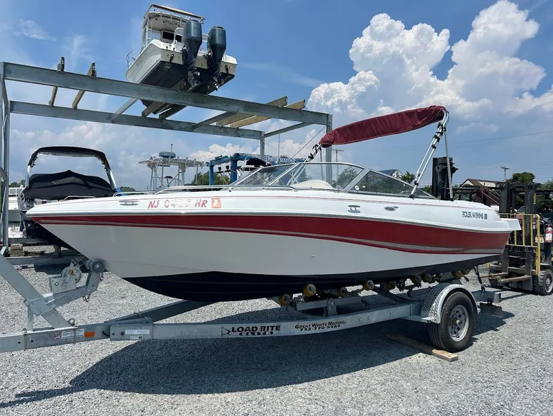 Slide: The Image of 2004 Four Winns 200 Horizon boat on trailer, red and white design, sunny day. - 1