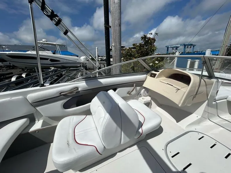 Slide: The Image of 2004 Four Winns 200 Horizon boat interior with white seating and dashboard. - 13