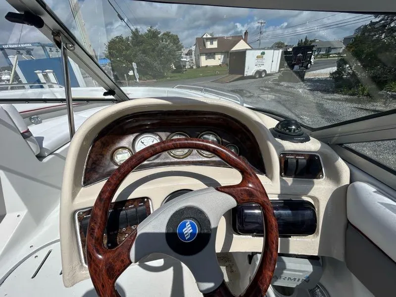 Slide: The Image of 2004 Four Winns 200 Horizon boat dashboard with wood-trimmed steering wheel and instrument panel. - 16