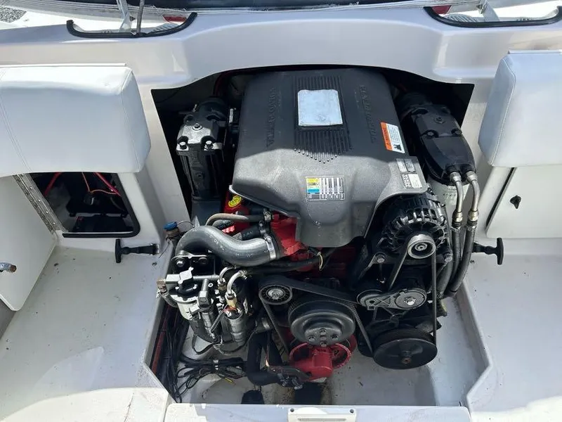 Slide: The Image of Engine compartment of a 2004 Four Winns 200 Horizon boat, showcasing detailed components. - 18