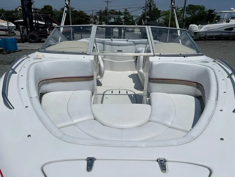 Slide: The Image of 2004 Four Winns 200 Horizon boat with white seating and open bow design. - 3