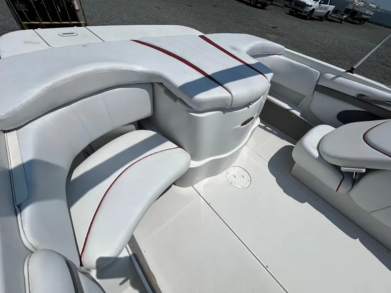 Slide: The Image of 2004 Four Winns 200 Horizon boat interior with white seating and red accents. - 6