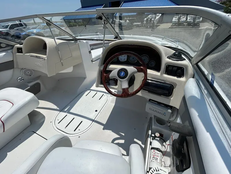 Slide: The Image of 2004 Four Winns 200 Horizon boat interior with steering wheel and dashboard controls. - 8