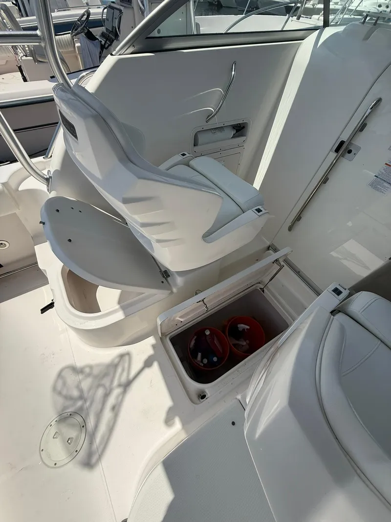 Slide: The Image of 2014 Robalo R245 Walkaround boat interior with storage compartment and seating. - 10