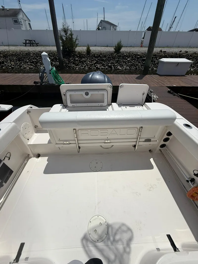 Slide: The Image of 2014 Robalo R245 Walkaround boat interior with seating and storage compartments. - 12