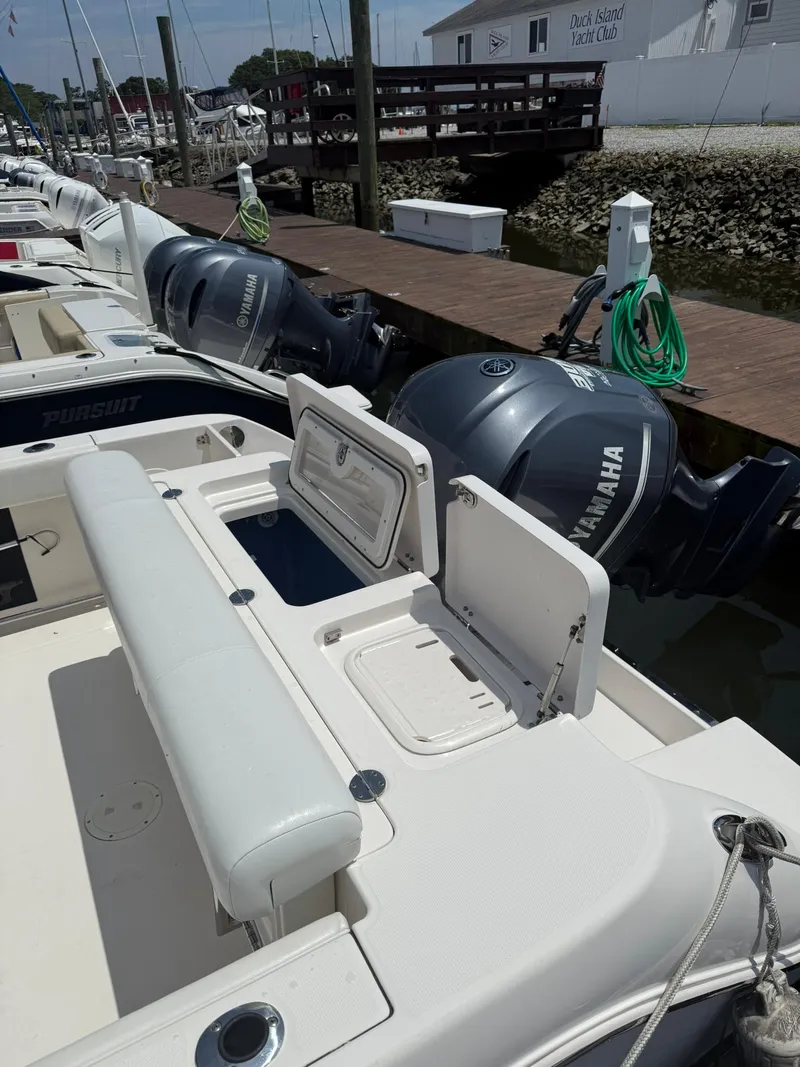 Slide: The Image of 2014 Robalo R245 Walkaround boat with Yamaha engines docked at marina. - 3
