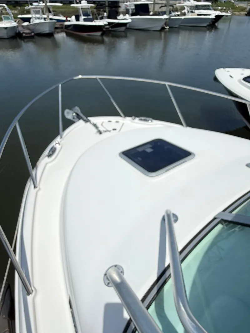 Slide: The Image of 2014 Robalo R245 Walkaround boat docked in a marina. - 8