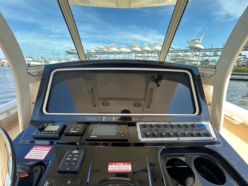 Slide: The Image of 2018 Scout 275 LXF boat dashboard with controls and navigation equipment. - 11