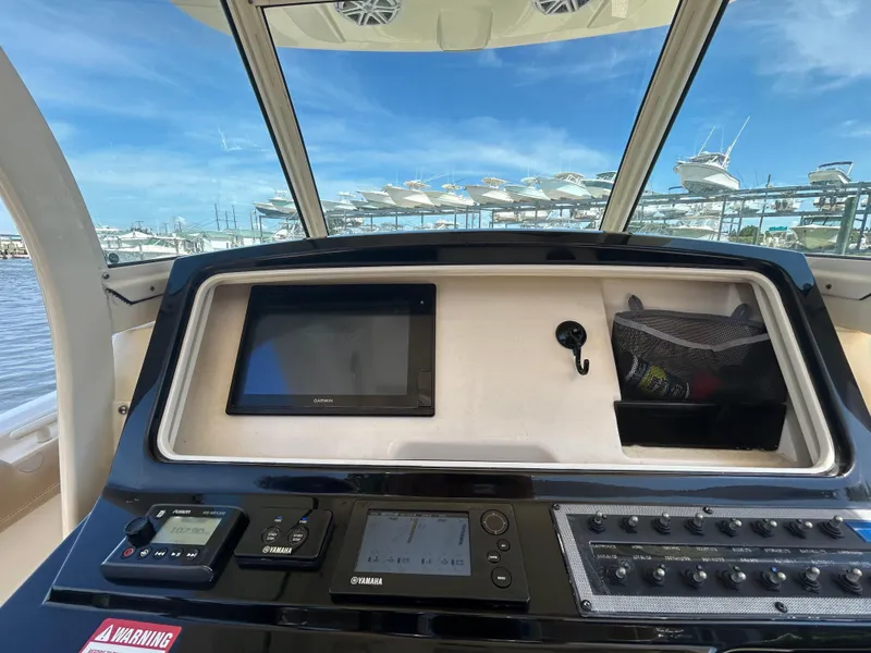 Slide: The Image of 2018 Scout 275 LXF boat dashboard with Garmin display and Yamaha controls. - 12