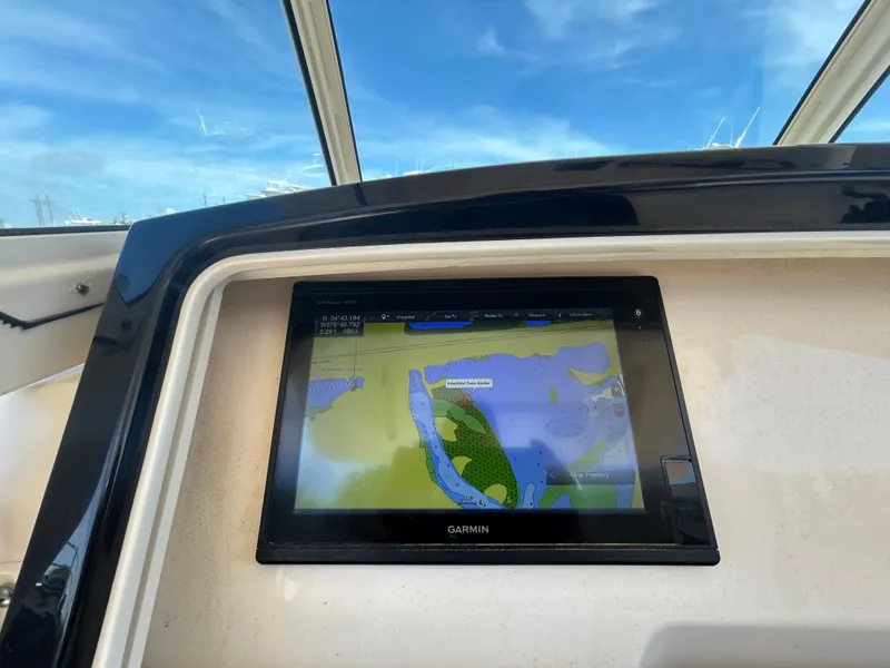 Slide: The Image of Garmin navigation display on 2018 Scout 275 LXF boat, showing a detailed marine map. - 13