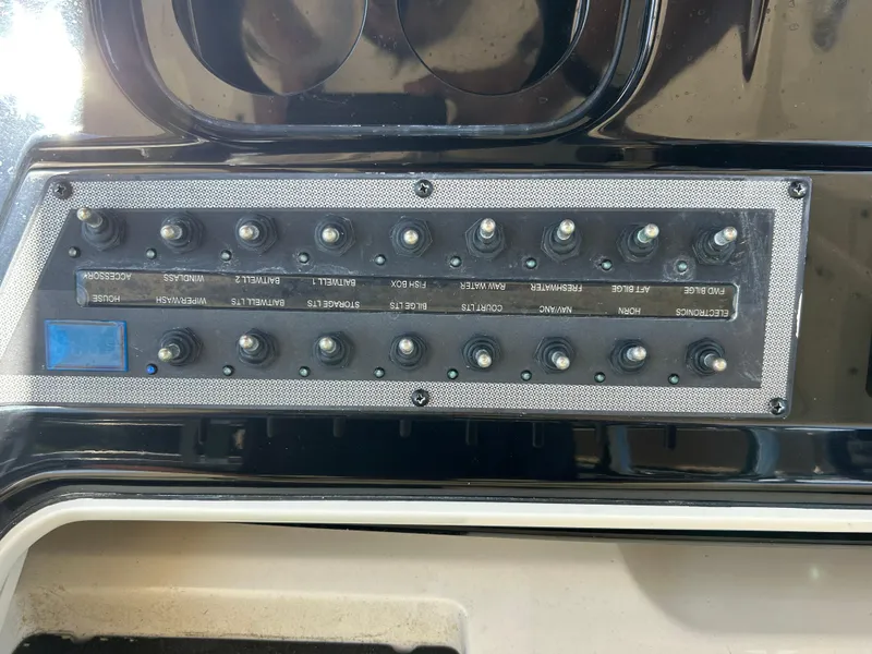 Slide: The Image of Control panel of a 2018 Scout 275 LXF boat with labeled switches. - 16