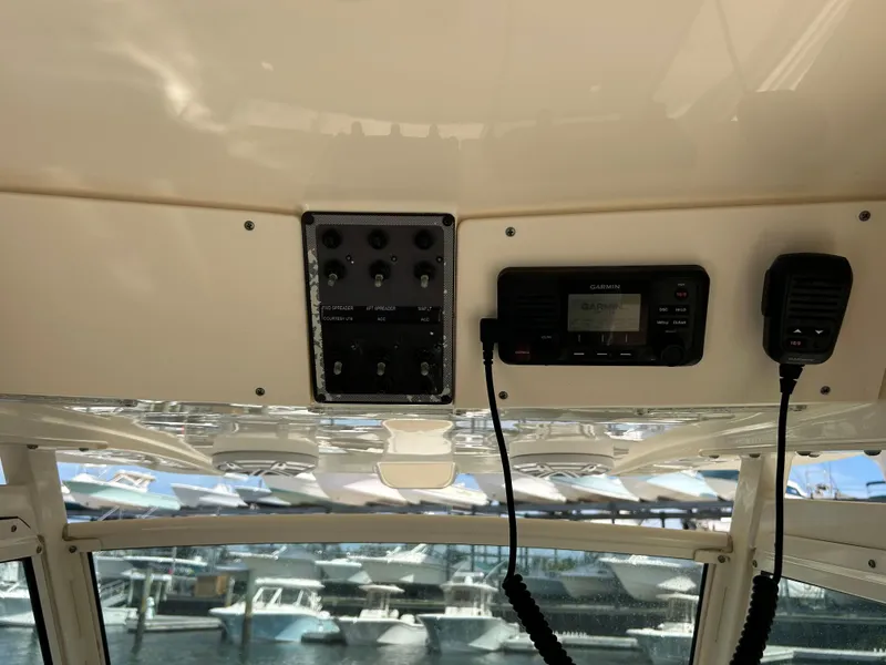Slide: The Image of 2018 Scout 275 LXF boat dashboard with Garmin radio and control panel. - 17