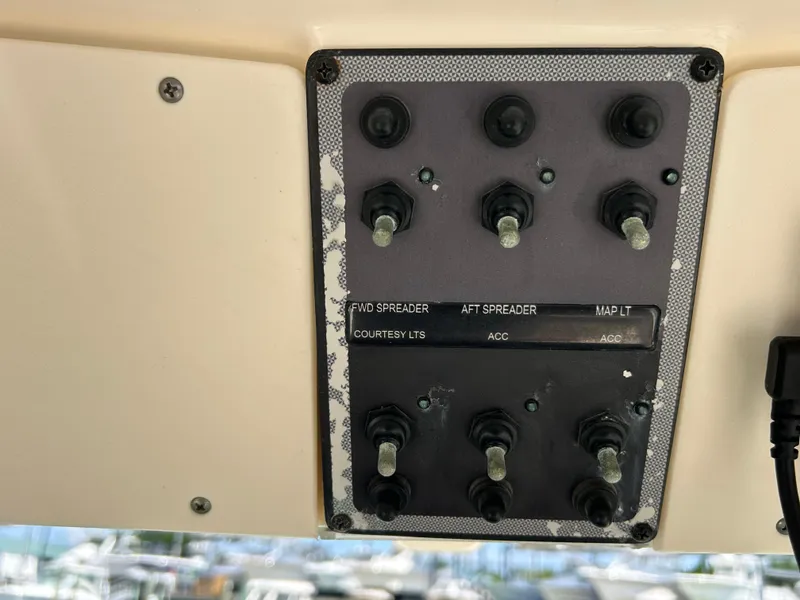 Slide: The Image of Control panel of a 2018 Scout 275 LXF boat with labeled switches. - 18