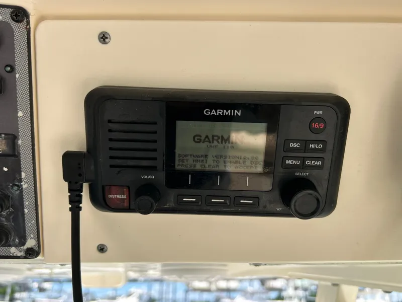 Slide: The Image of Garmin VHF radio on 2018 Scout 275 LXF boat dashboard. - 19