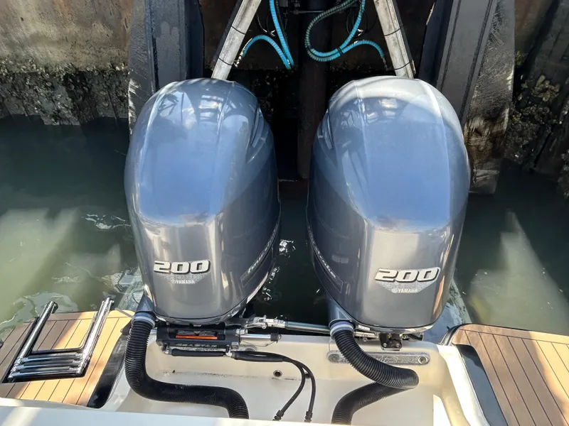 Slide: The Image of Twin Yamaha 200 engines on a 2018 Scout 275 LXF boat at dock. - 4