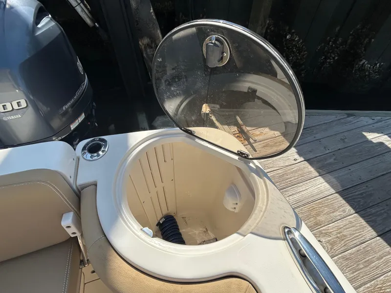 Slide: The Image of Open hatch on 2018 Scout 275 LXF boat, showing interior storage compartment. - 7