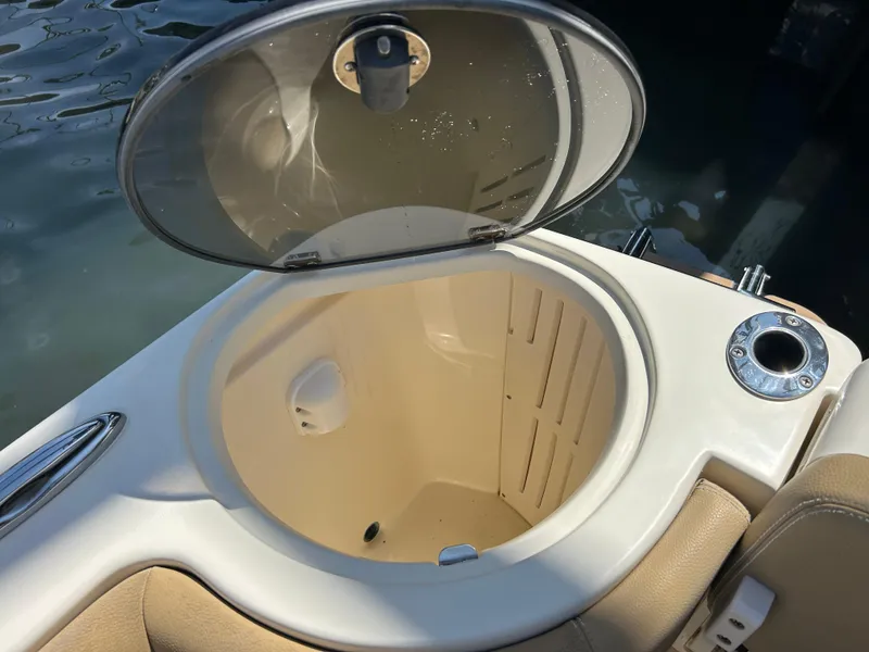 Slide: The Image of Open storage compartment on 2018 Scout 275 LXF boat, near water. - 8