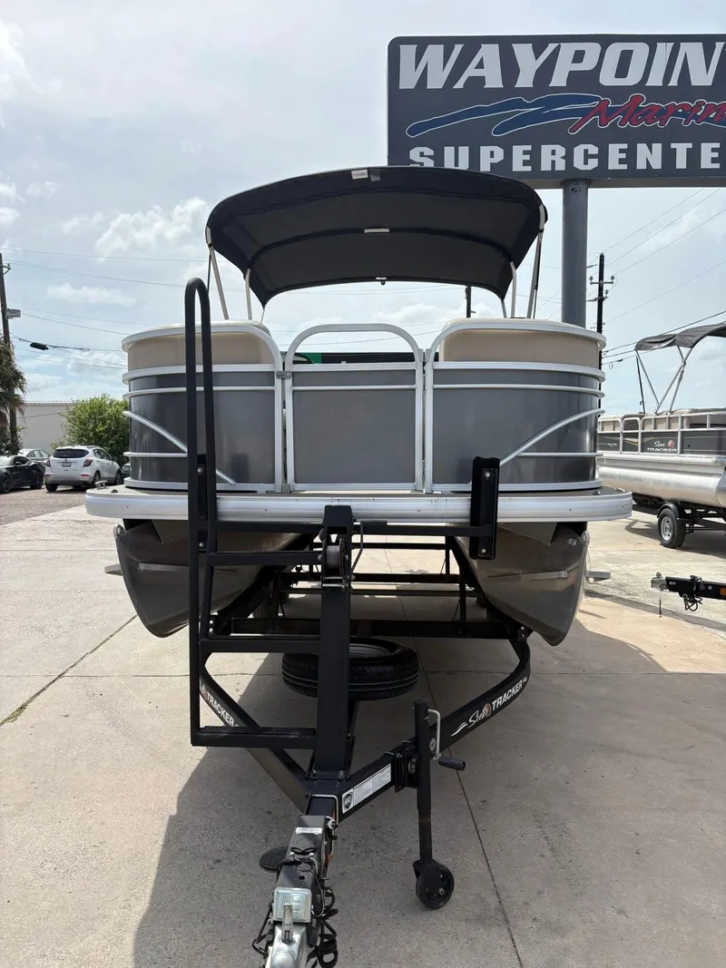 Slide: The Image of 2023 Sun Tracker Party Barge 20 DLX pontoon boat on trailer at dealership. - 14