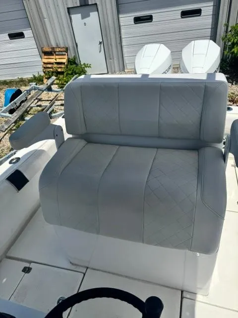 Slide: The Image of 1999 SeaVee 260B boat with cushioned seating and dual outboard motors in a marina setting. - 11