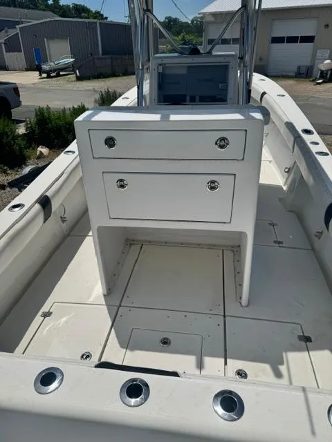 Slide: The Image of 1999 SeaVee 260B boat interior with storage drawers and rod holders. - 12