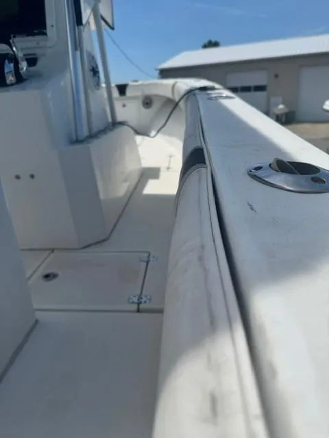 Slide: The Image of 1999 SeaVee 260B boat deck with rod holders and storage compartments. - 15