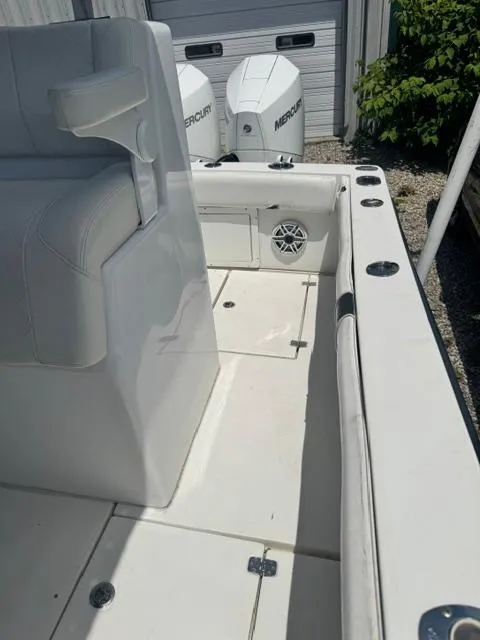 Slide: The Image of 1999 SeaVee 260B boat interior with Mercury engines, white seating, and deck details. - 19