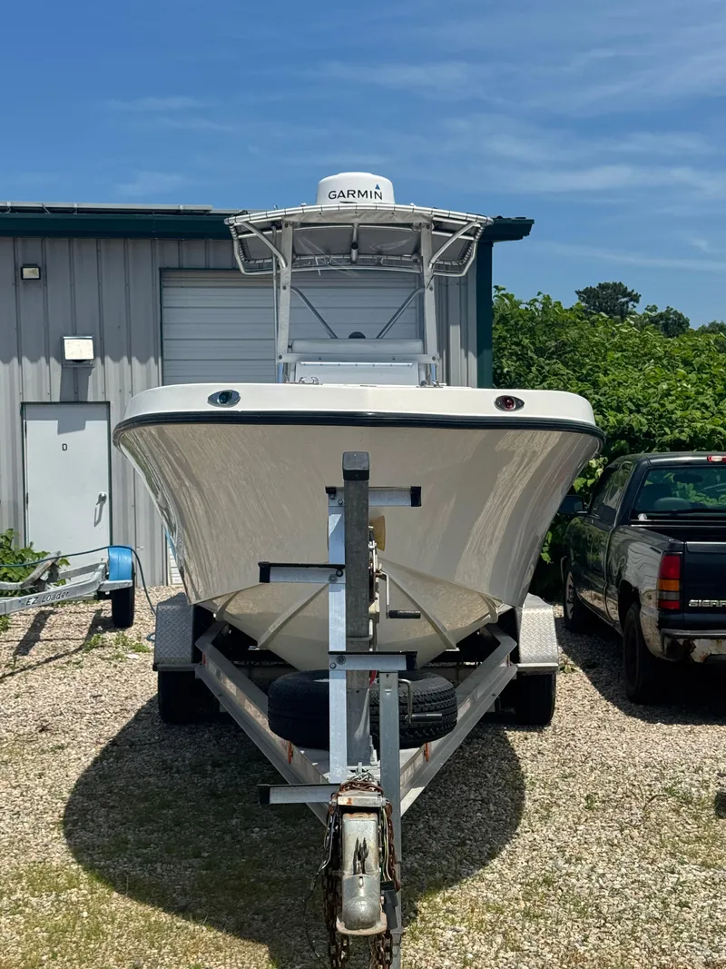 Slide: The Image of 1999 SeaVee 260B boat on trailer, parked outdoors near a building. - 2