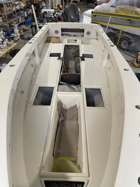 Slide: The Image of 1999 SeaVee 260B boat interior, showing spacious deck and storage compartments in a workshop. - 21