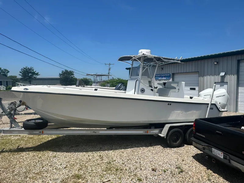 Slide: The Image of 1999 SeaVee 260B boat on trailer, parked outdoors near a building. - 4
