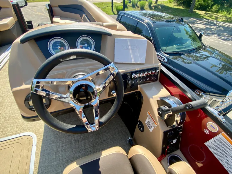 Slide: The Image of 2022 Barletta C24UC boat dashboard with steering wheel and control panel. - 10