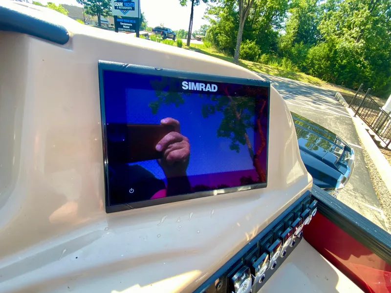 Slide: The Image of Simrad display on 2022 Barletta C24UC boat dashboard, reflecting outdoor scenery. - 11