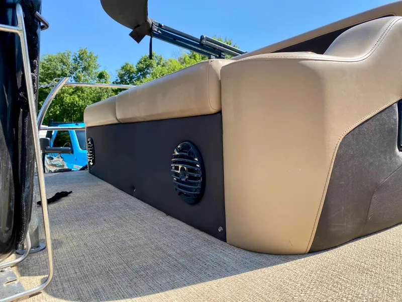 Slide: The Image of 2022 Barletta C24UC boat interior with beige seating and speaker detail. - 3