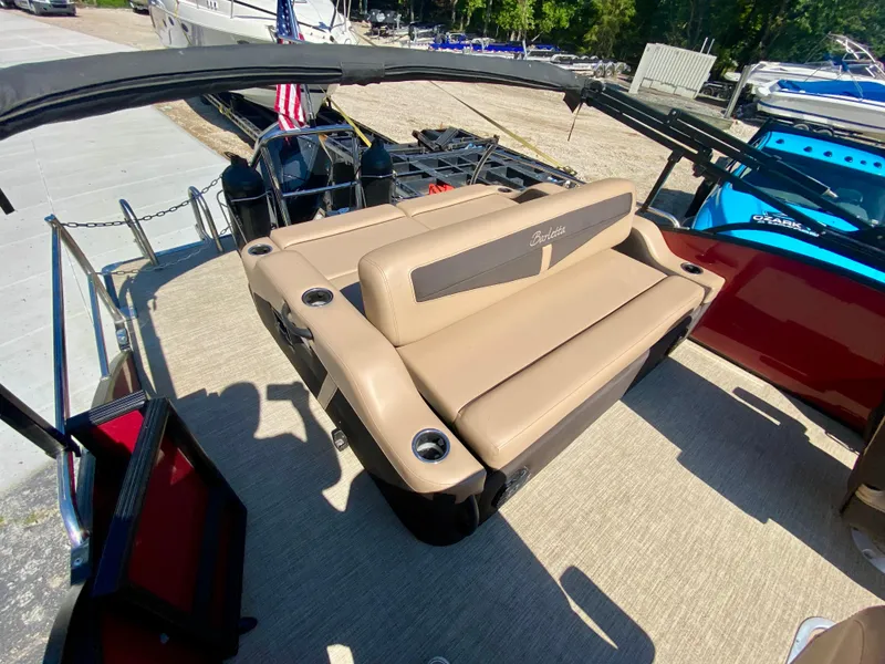 Slide: The Image of 2022 Barletta C24UC boat interior with tan seating and cup holders. - 4