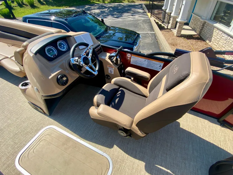Slide: The Image of 2022 Barletta C24UC boat cockpit with steering wheel and captain's chair. - 9