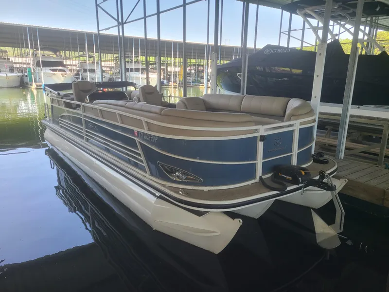 Slide: The Image of 2018 Regency 254 LE3 pontoon boat docked in a marina. - 1