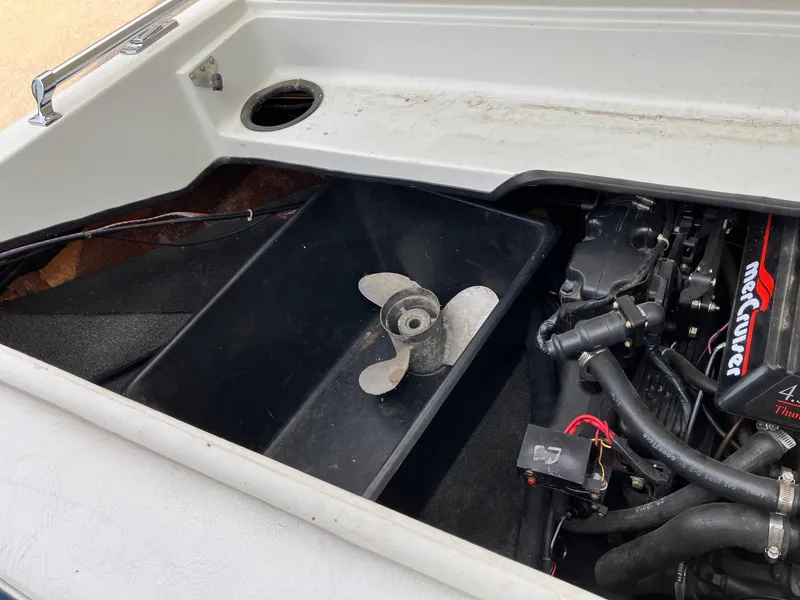 Slide: The Image of 1989 Rinker 206 Open Bow boat engine compartment with propeller and MerCruiser components. - 10