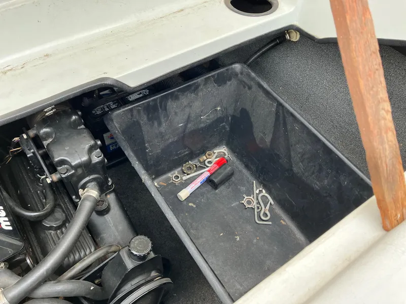 Slide: The Image of Engine compartment of a 1989 Rinker 206 Open Bow boat with tools and parts. - 11