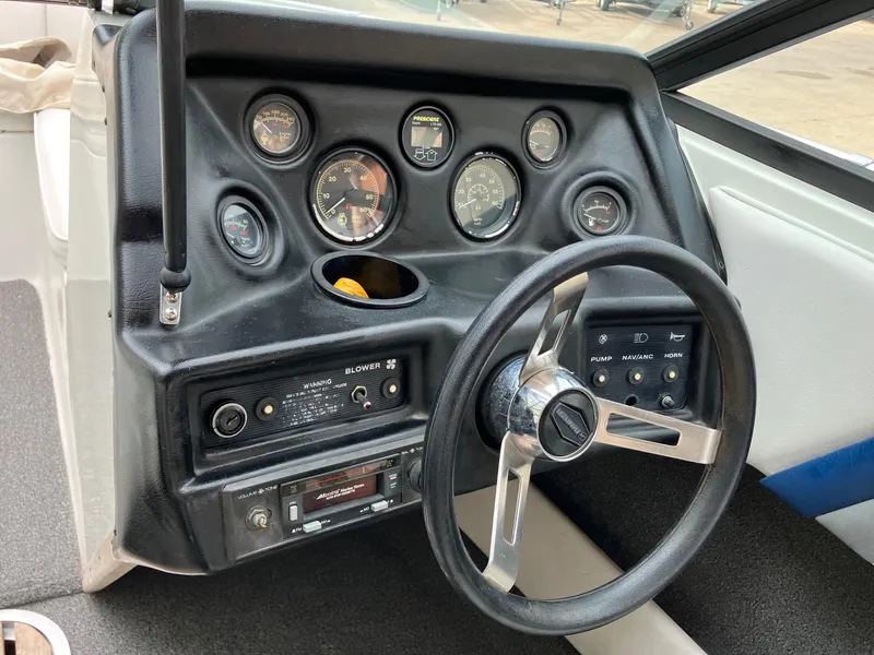 Slide: The Image of 1989 Rinker 206 Open Bow dashboard with steering wheel and instrument panel. - 13