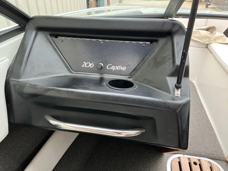 Slide: The Image of 1989 Rinker 206 Open Bow Captiva boat interior with cup holder and handle. - 14