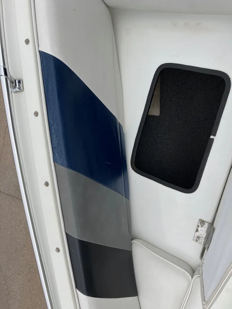 Slide: The Image of 1989 Rinker 206 Open Bow boat interior with blue and gray seating. - 17