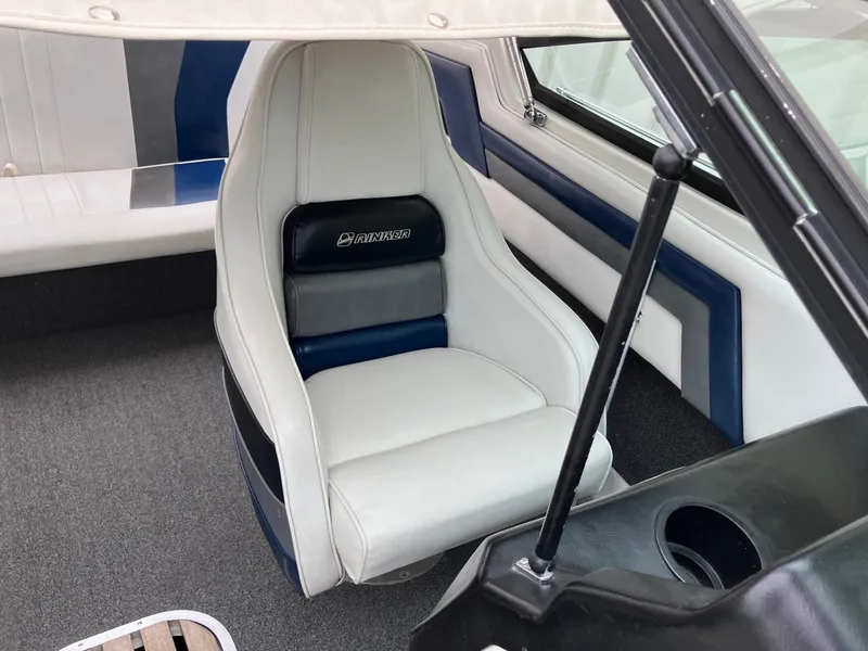 Slide: The Image of 1989 Rinker 206 Open Bow boat interior with white and blue seating. - 19