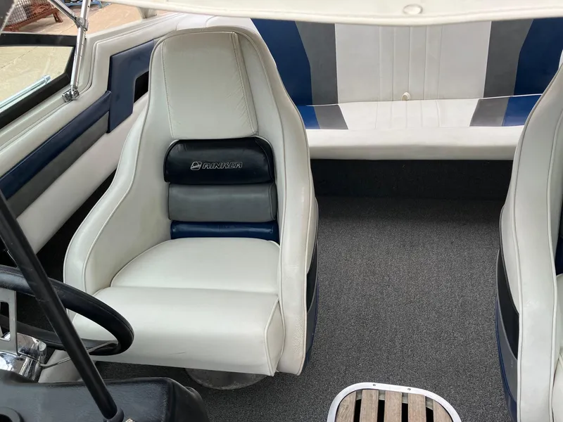 Slide: The Image of 1989 Rinker 206 Open Bow boat interior with white and blue seating. - 20