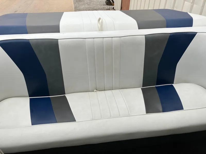 Slide: The Image of 1989 Rinker 206 Open Bow boat seat with blue, gray, and white upholstery. - 7