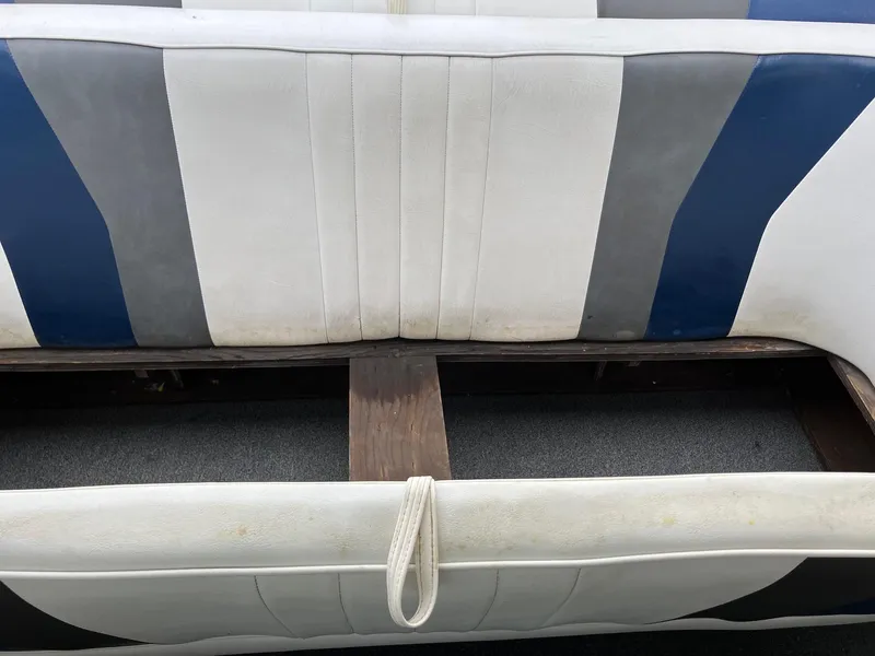 Slide: The Image of 1989 Rinker 206 Open Bow boat interior with blue, gray, and white seating. - 8