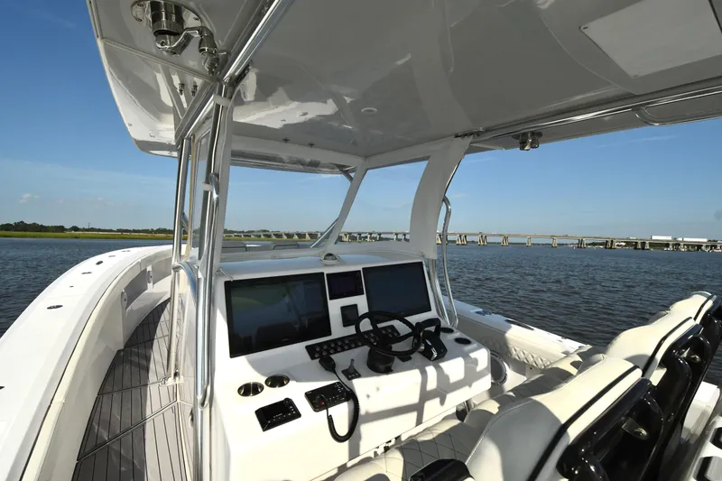 Slide: The Image of 2022 Front Runner 39 Center Console boat interior with dual screens, steering wheel, and seating. - 18