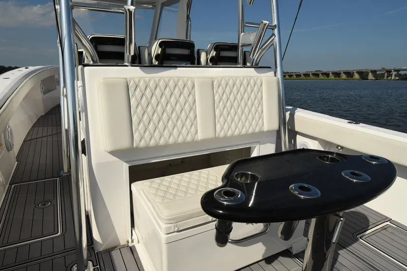 Slide: The Image of 2022 Front Runner 39 Center Console boat interior with cushioned seating and rod holders. - 20